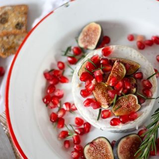 overhead oven baked brie on white and red enamel plate