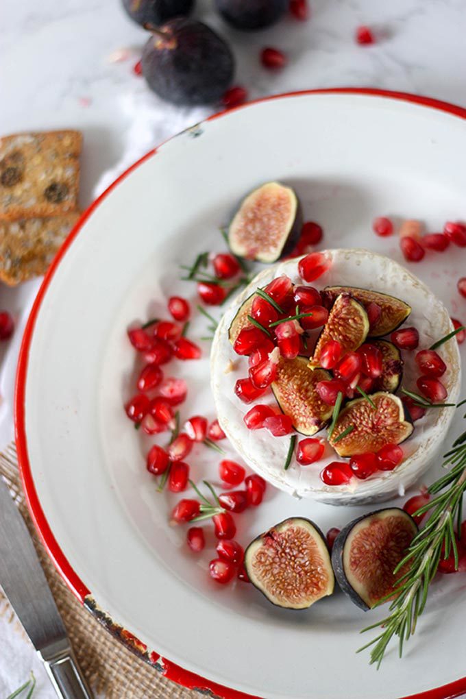 overhead oven baked brie on white and red enamel plate