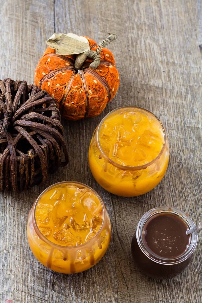 15 fall cocktails - two pumpkin apple punch glasses on wooden board