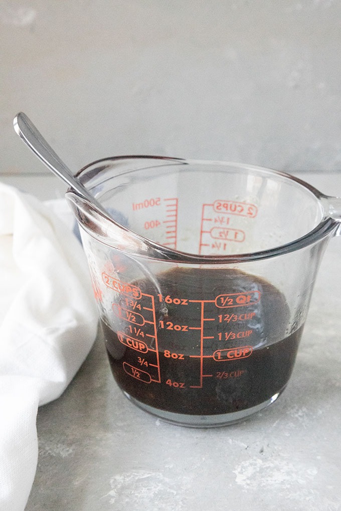 asian noodle salad dressing ingredients in a pyrex glass jar