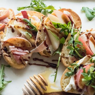 four slices of bruschetta on white marble board