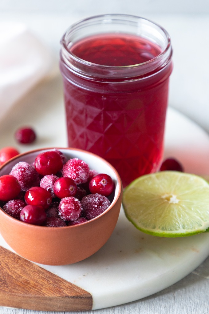 cranberries, cranberry juice and lime on marble board