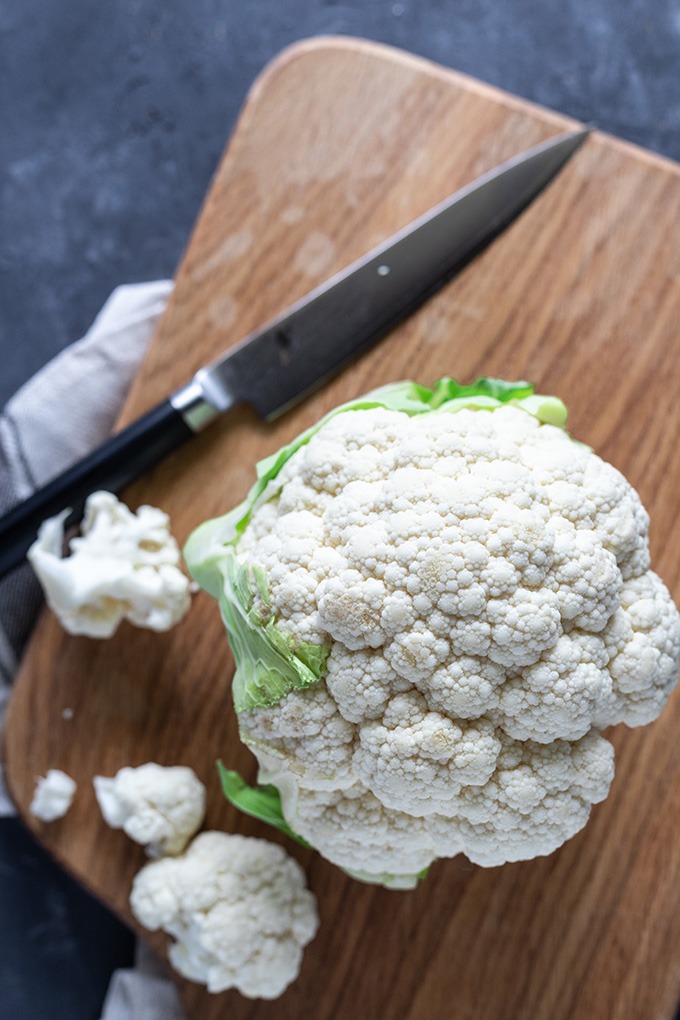 head of cauliflower on wooden board