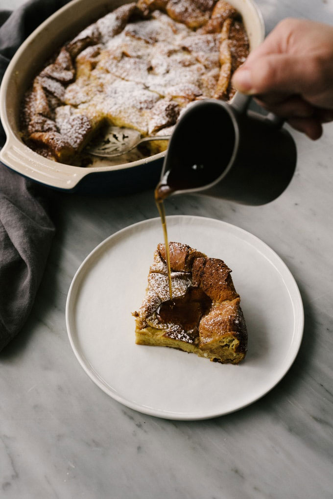 maple syrup being poured over a piece of french toast