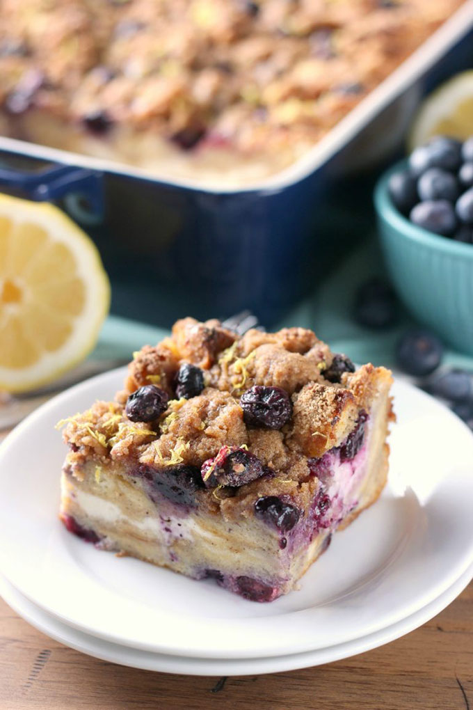 a slice of french toast on a white plate in front of blue casserole dish