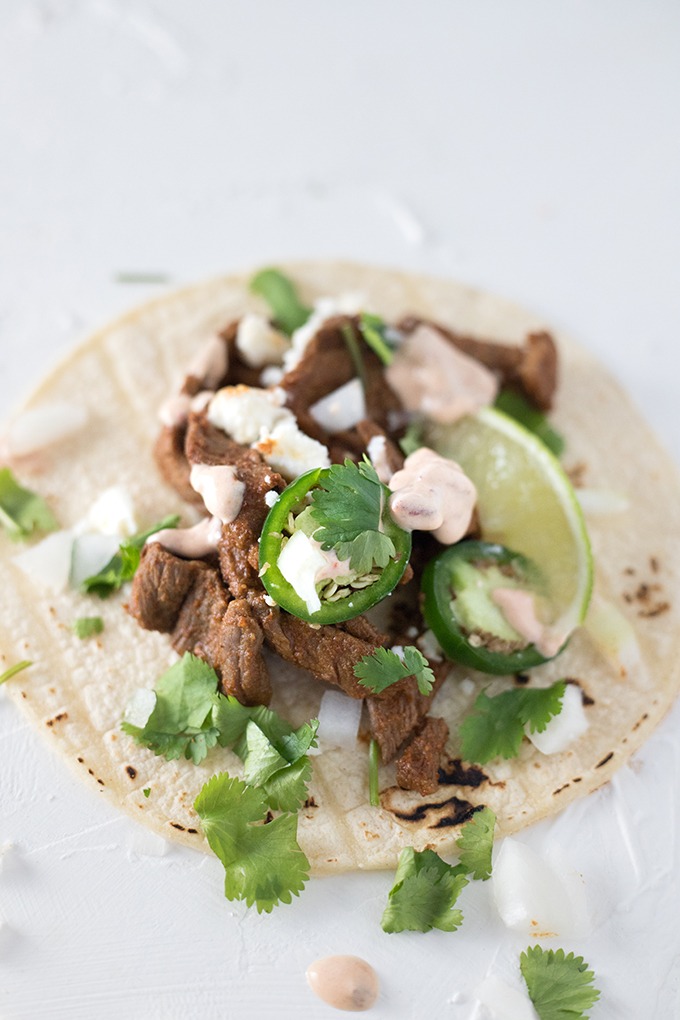 close up single taco with jalapeno, lime and chipotle dressing