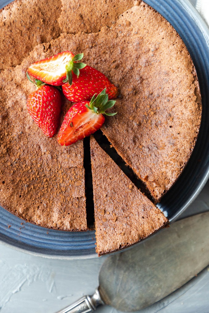 overhead flourless chocolate torte with slice missing