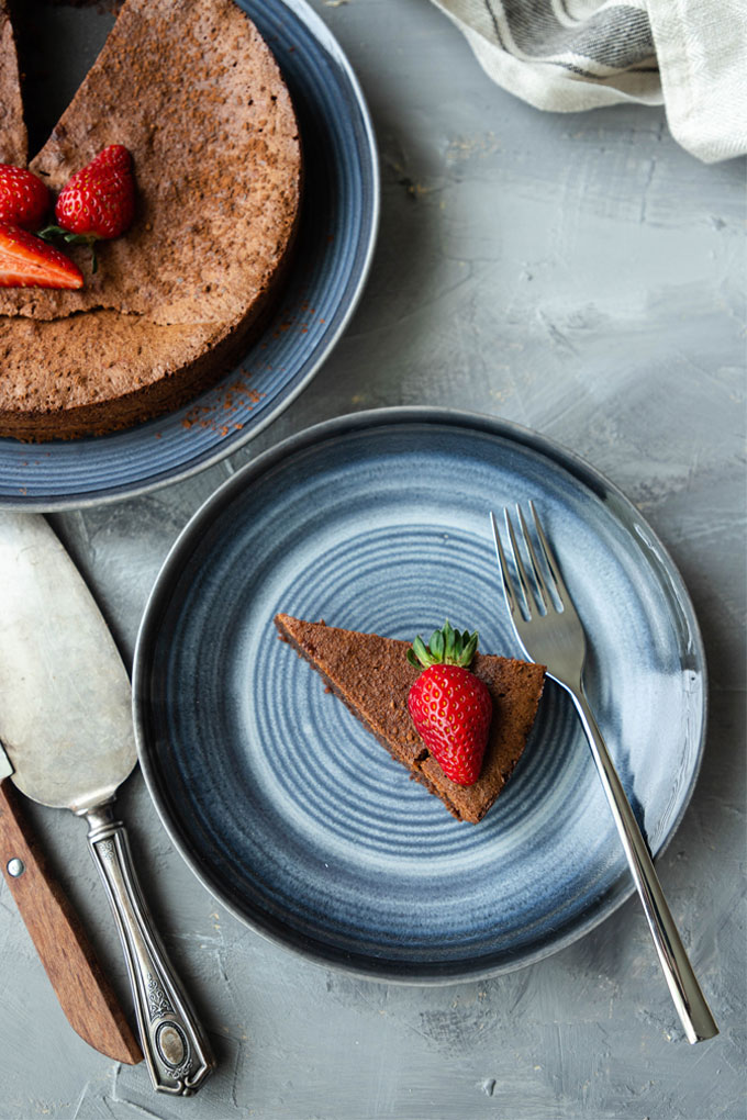 slice of flourless chocolate torte on blue plate