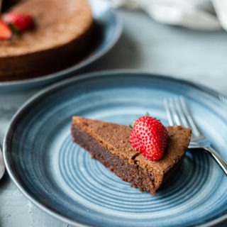 slice of flourless chocolate torte on blue plate