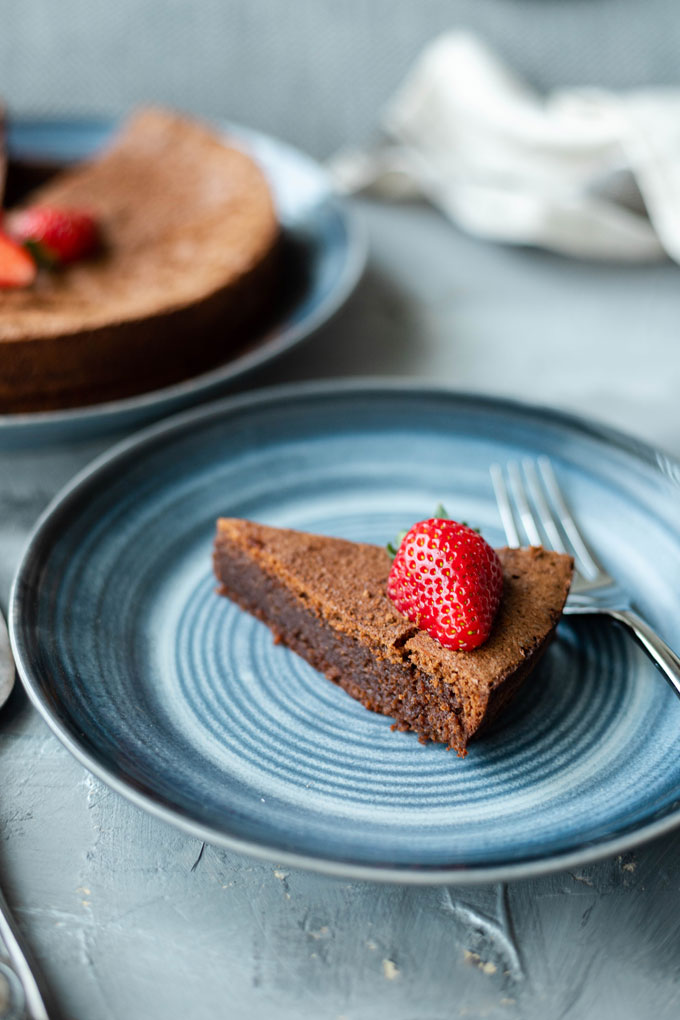 slice of flourless chocolate torte on blue plate