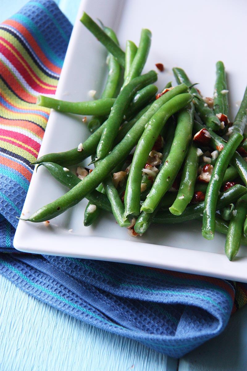 green beans with hazelnut garlic butter www.thehomecookskitchen.com perfect for a winter side dish, crunchy and oh so buttery.