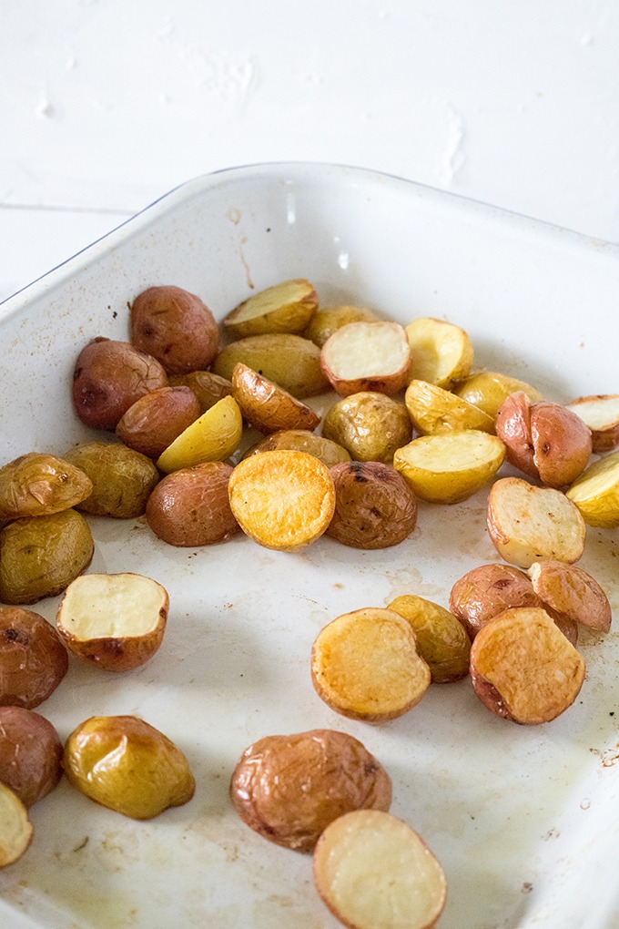 crispy roasted potatoes in a white enamel pan