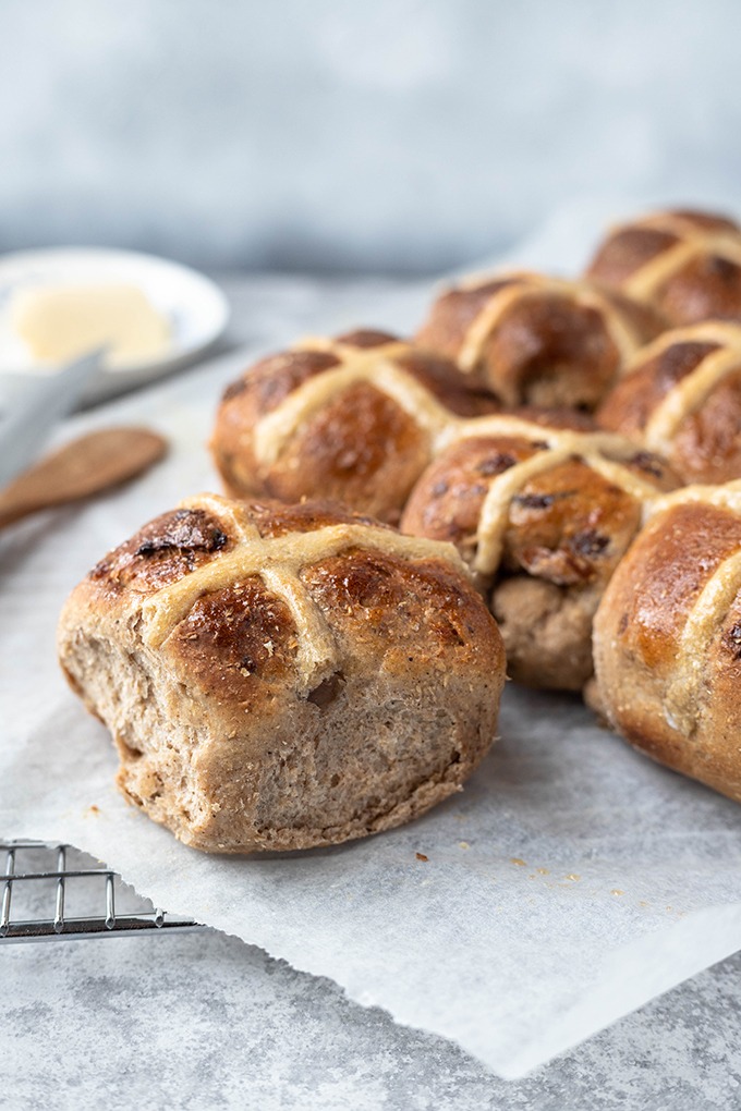 close up hot cross bun on parchment paper 