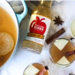 Pinterest graphic - glasses of cider with clear banner at top of image and 'hot spiced apple cider' text