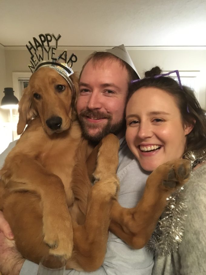 me and my husband holding our golden retriever puppy for new years eve