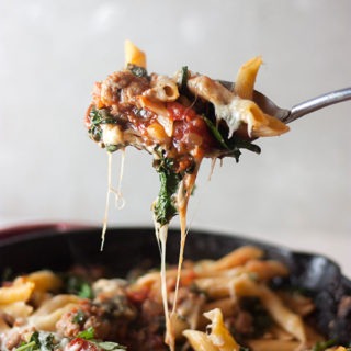 cheesey italian sausage and kale pasta bake in skillet