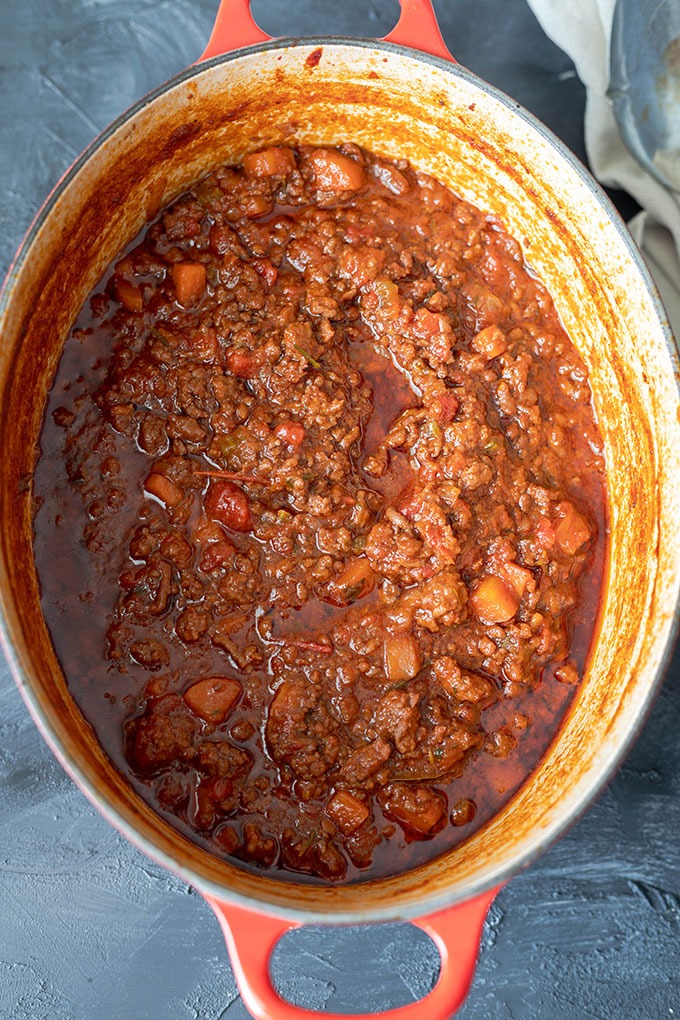 cooked lamb ragu in red dutch oven