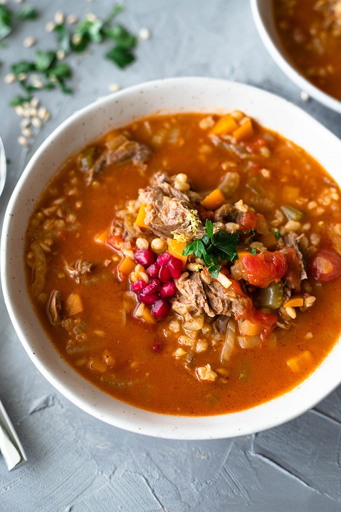 lamb shank soup in large white bowl 