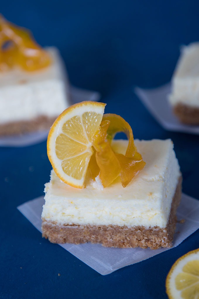 One slice of the lemon cheesecake bars on parhment paper