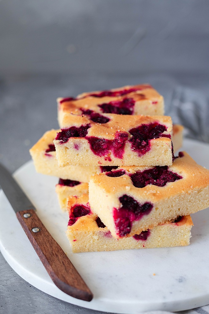 lemon sour cream cake on marble board with knife