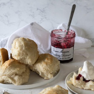 plate of lemonade scones in front of jam jar