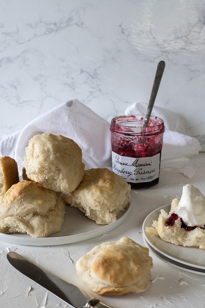 plate of lemonade scones in front of jam jar 