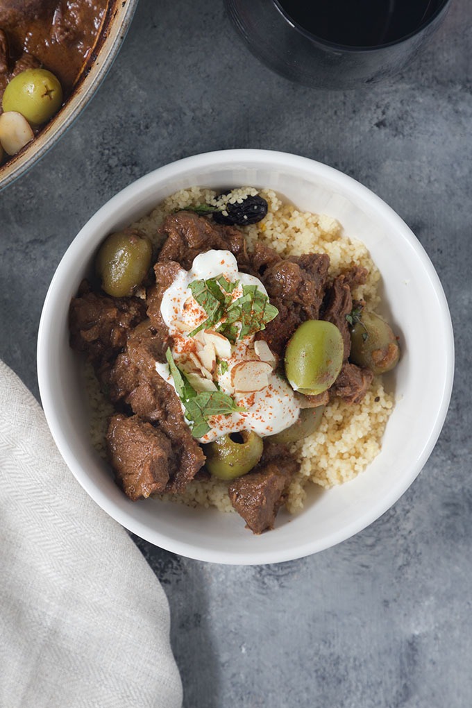 close up white bowl of moroccan lamb tagine with couscous