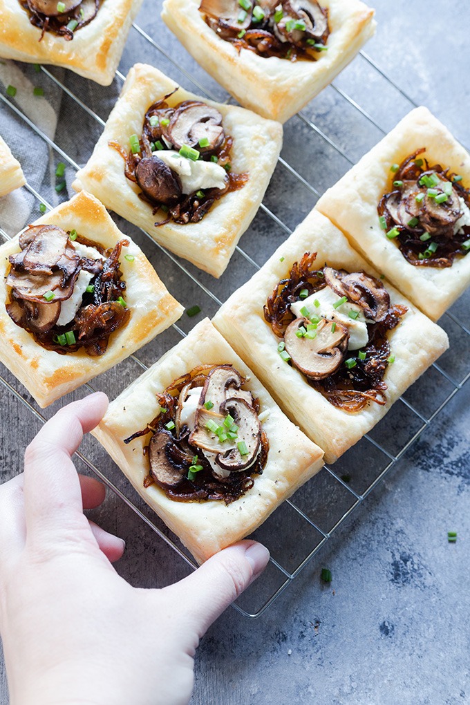 hand reaching to grab mushroom tart