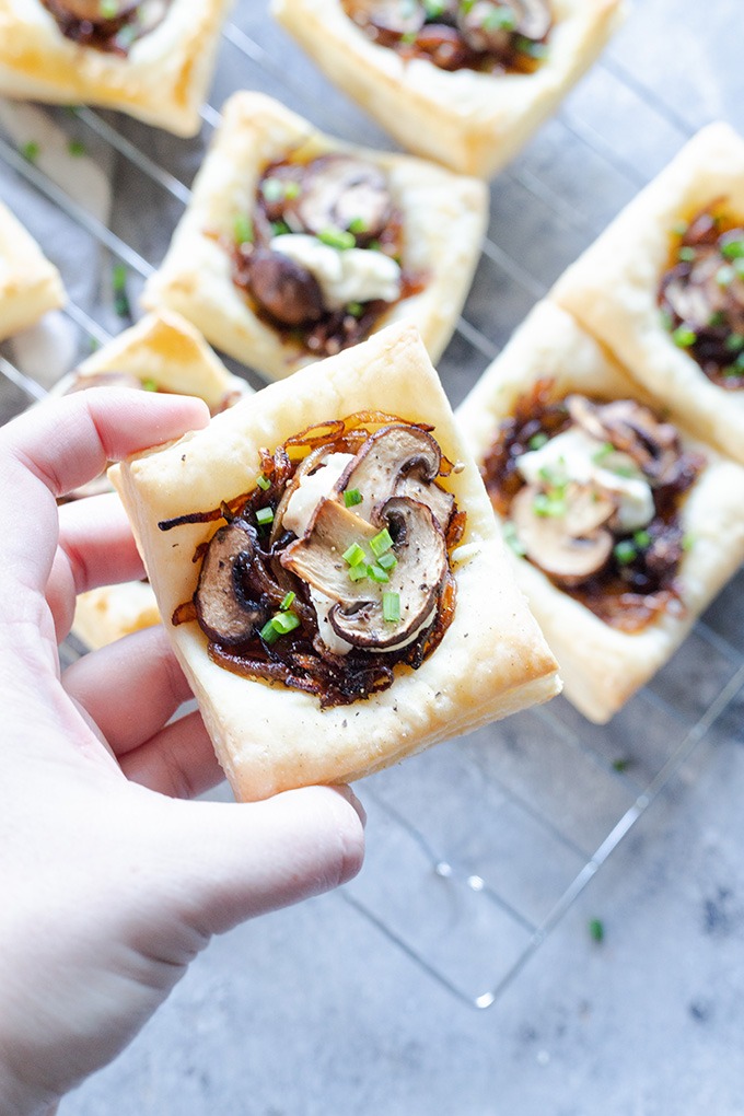 hand holding up mushroom tart