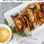 oven baked fries on a white plate, on top of a white linen