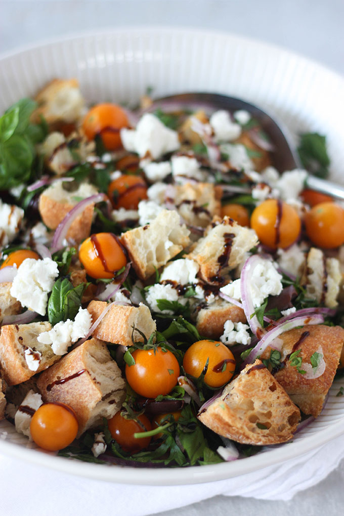 panzanella salad in white bowl with antique spoon