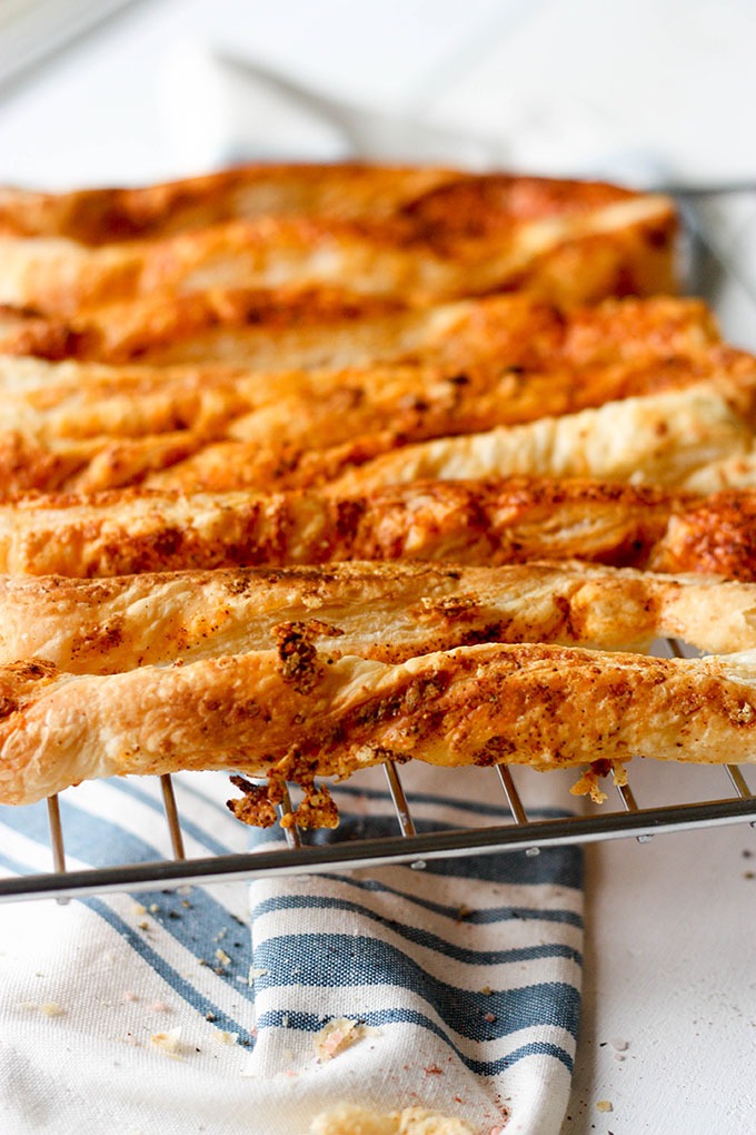 wire rack filled with puff pastry cheese straws