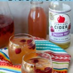 pinterest graphic - two glasses of passionfruit cider punch on a colourful napkin with blue header and text