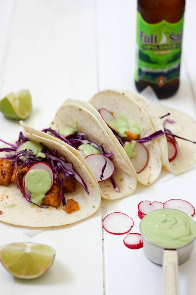 white board with healthy fish tacos on them filled with radish and cabbage. 