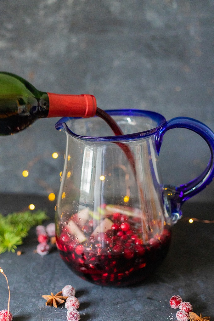 red wine being poured into pitcher