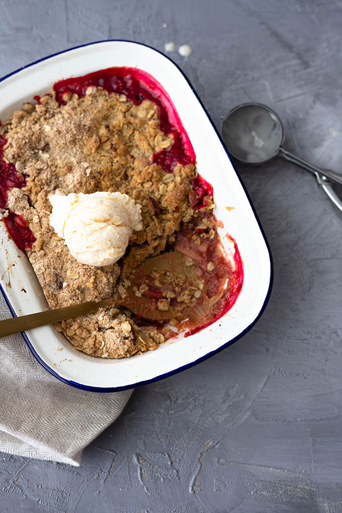 rhubarb crumble in enamel dish with ice cream and scoop