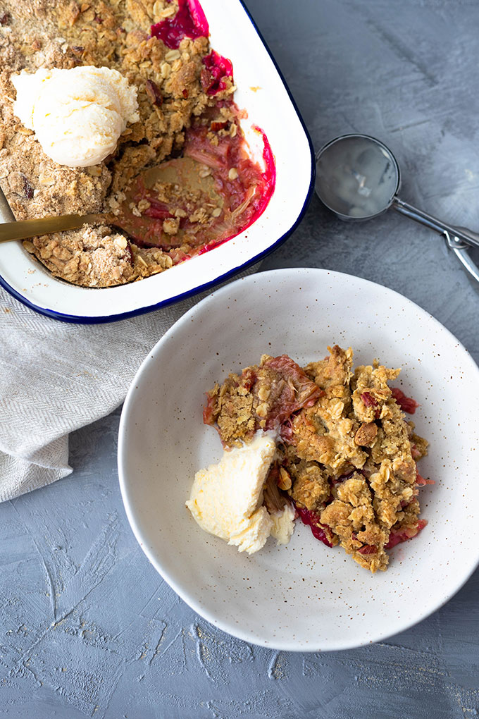 rhubarb crumble in bowl with ice cream