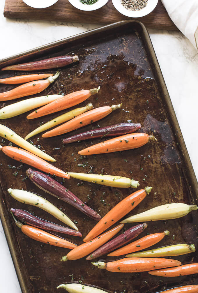 multicolored carrots on a baking tray