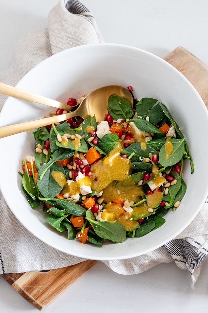 dressing poured into sweet potato salad