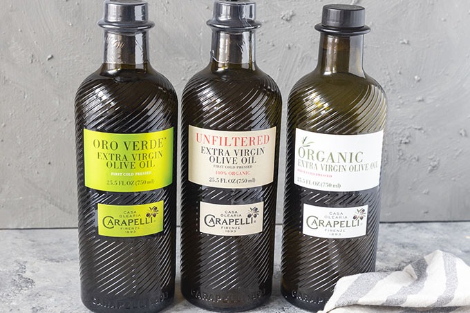 three bottles of carapelli olive oil