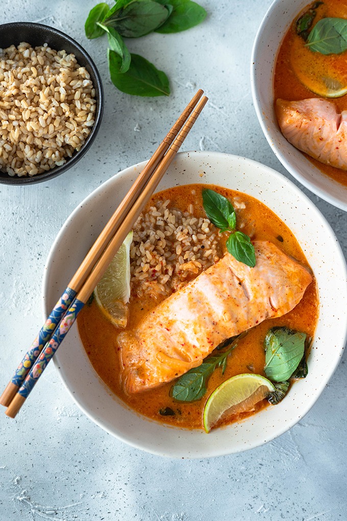 salmon curry in bowl with rice and chopsticks