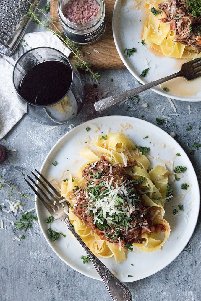 slow cooker beef ragu with pappardelle on white plate with antique spoon