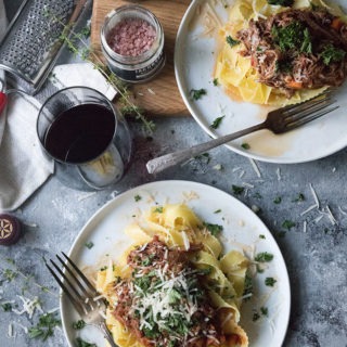 two plates of slow cooker beef ragu on white plates