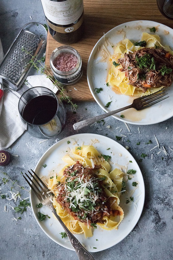 two plates of slow cooker beef ragu on white plates