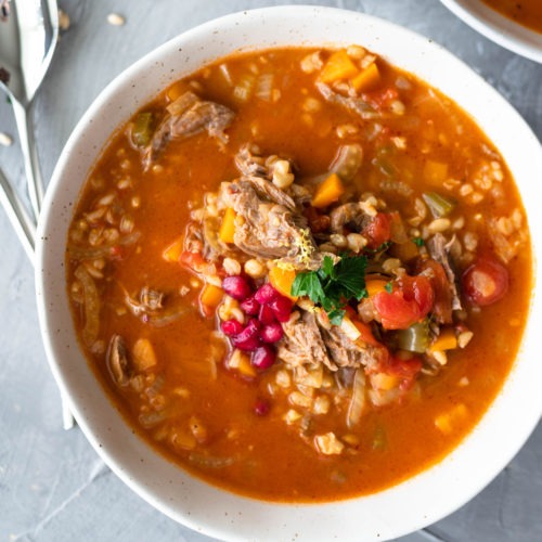 lamb shank soup in a white bowl