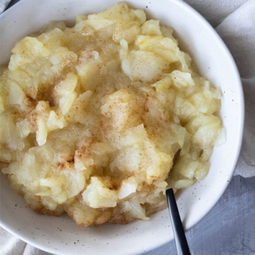 stewed apple in bowl with spoon