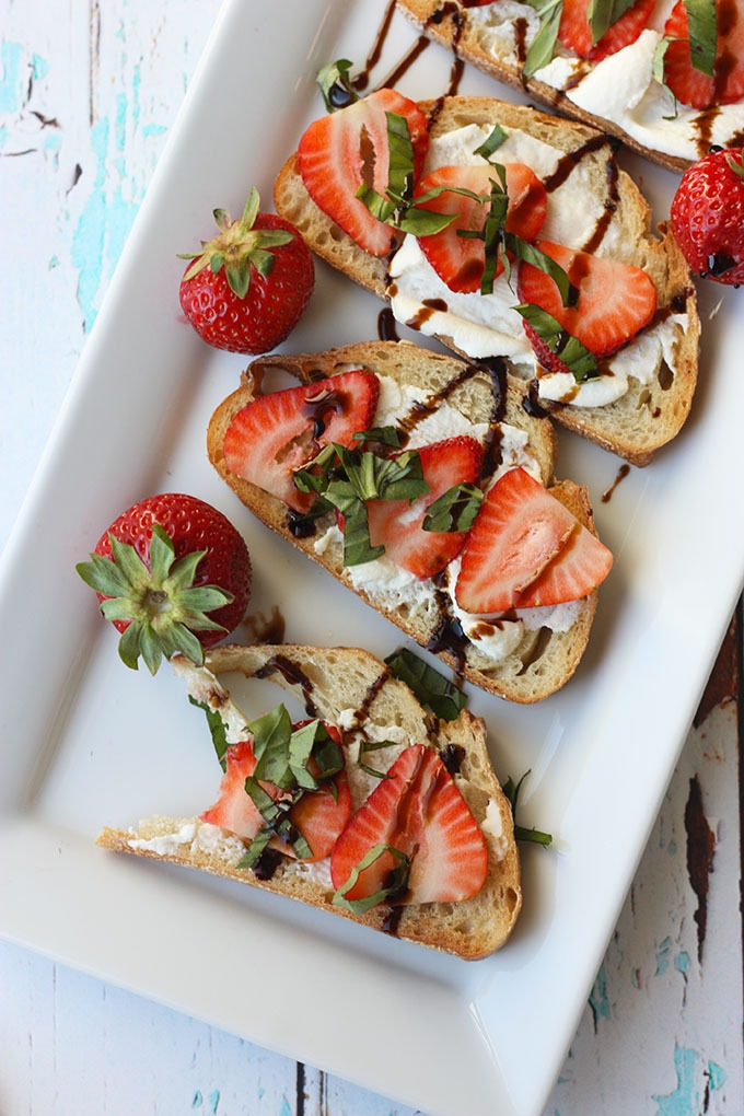 plate of strawberry bruschetta on white rectangular plate