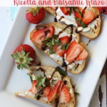 strawberry bruschetta on white plate with text on top of image for Pinterest