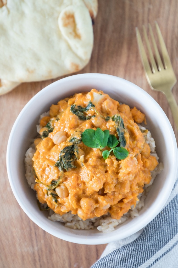 sweet potato chickpea curry in white bowl on wooden surface