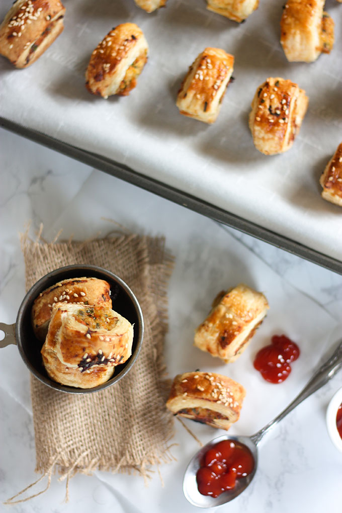 tray of thai sausage rolls top of image, sausage rolls in antique metal cup in bottom